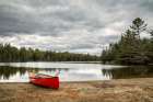 USA, New York, Adirondacks. Lake Abanakee, Red canoe on Chain Lakes Bathing Beach Art Print